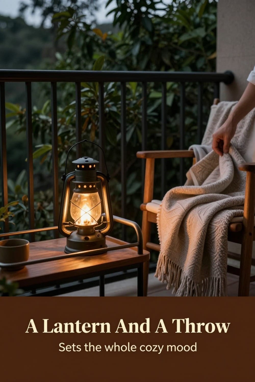Warm lantern glow and a draped throw blanket styled beside a small balcony coffee station at dusk